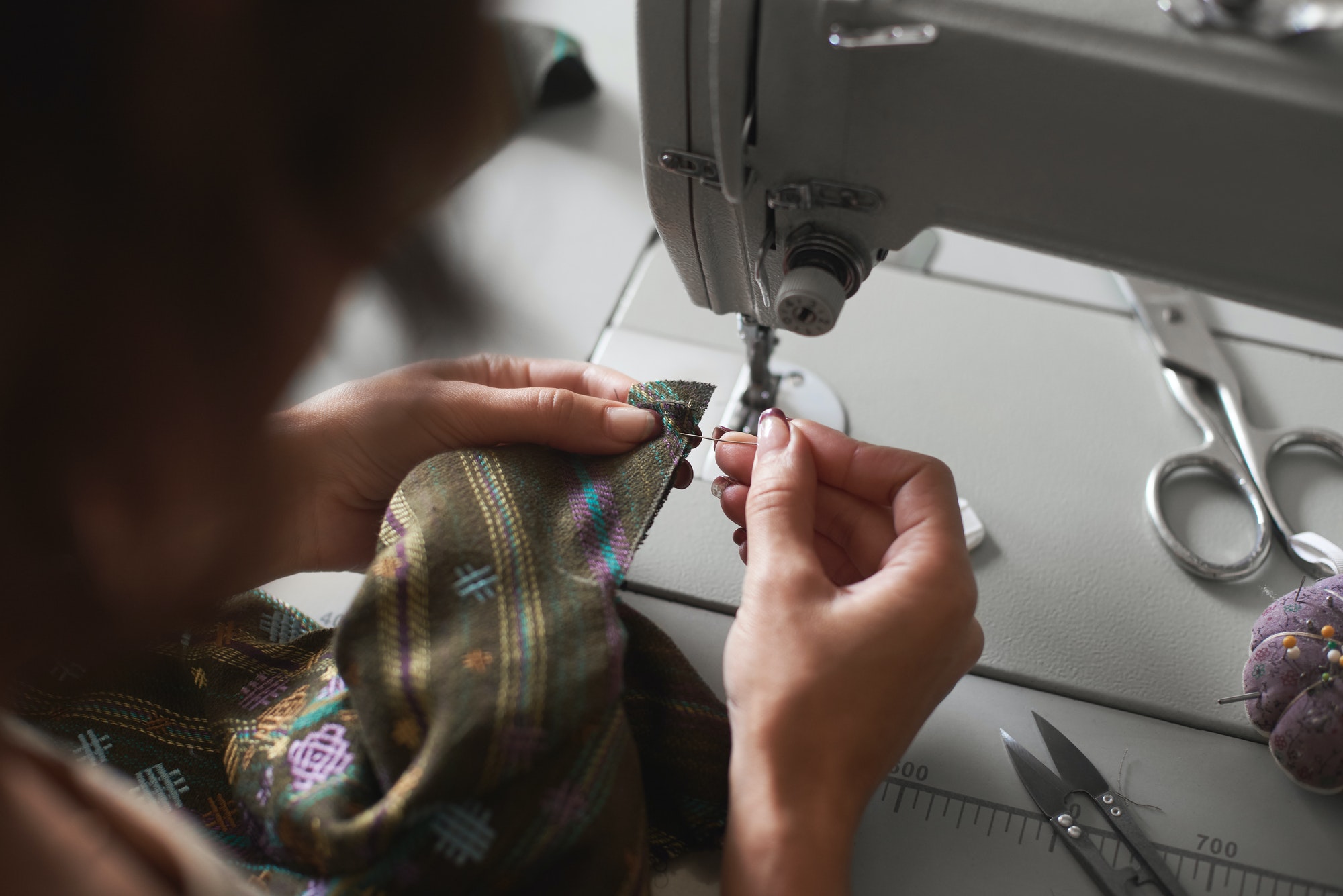 seamstress-working-on-modern-electrical-sewing-machine-making-exclusive-garments-in-fashion-studio-1-2.jpg